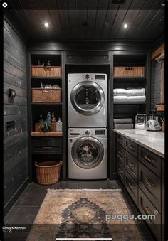 a washer and dryer in a room with dark wood paneling on the walls