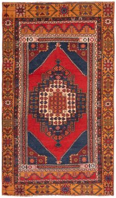 an orange, blue and red rug with geometric designs on the bottom half of it