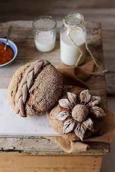 two loaves of bread sitting on top of a wooden table