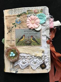 an altered book with flowers and birds on it