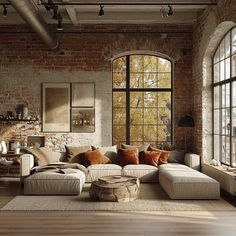 an industrial living room with brick walls and large windows