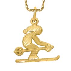 a gold plated necklace with a skier on the front and bottom part of it