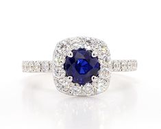 RareGemWorld's classic sapphire ring. Mounted in a beautiful 18K White Gold setting with a natural round cut blue sapphire. The sapphire is surrounded by natural round white diamond melee. This ring is guaranteed to impress and enhance your personal collection! Total Weight: 1.97cts Length x Width: 10.3 x 10.3 mm Sapphire Measurements: 5.72 x 5.70 mm Natural Round Blue Sapphire Natural Round White Diamonds  18K White Gold Size 6 1/2 Free sizing upon request All diamonds are guaranteed natural International Shipments: Please note that customers are responsible for all import duties and taxes applicable to the country of shipment Returns: Returns accepted in original format within 14 days of receipt Do not forget to view our entire inventory! Thank you for reviewing our item Round Sapphire, White Gold Set, Gold Cocktail Ring, Gold Cocktail, White Diamonds, Cocktail Ring, Cocktail Rings, Rings Statement, White Diamond