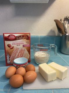 eggs, butter, and other ingredients on a counter with a blue tile back splash