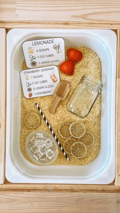 a tray filled with different items like strawberries, lemonade and cookie cutters