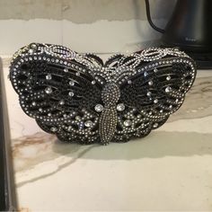 Swarovski Crystal Elements Black & Silver Crystals Butterfly Bag! Secure String Magnetic Closure! Heavy! Top Quality! Clutch Bag Is 7” High By 3 7/8” Long! Inside Is About 3” Deep! Bag Has Never Been Used! Free First Class Domestic Shipping! Will Be Packed & Shipped W Care! We Double Box All Our Crystal Bags! Luxury Black Embellished Clutch, Designer Evening Bags With Silver Accents, Luxury Silver Clutch, Silver Bling Bags For Night Out, Designer Silver Clutch For Formal Events, Designer Silver Clutch For Formal Occasions, Designer Black Evening Bag For Party, Designer Black Evening Bag For Events, Designer Silver Clutch As A Gift