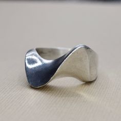 Vintage sterling silver modernist wave design ring. Signed MEXICO. Era: c.1970s Markings: MEXICO 925 Material: Sterling Silver Ring Size: 9.5 (Comes with one free resizing by our jeweler) Weight: 15.1 grams Condition: Good vintage condition with minor surface wear from age  Shipping is free in the United States  Follow us on Instagram @LUXXORVintage Modern Curved Rings With Polished Finish, Modern Wavy Jewelry For Anniversary, Modern Jewelry For Anniversary, Modern Wavy Rings With Polished Finish, Modern Wavy Silver Jewelry, Modernist Sterling Silver Rings, Modern Silver Wavy Rings, Wax Jewelry, Silver Ring Design