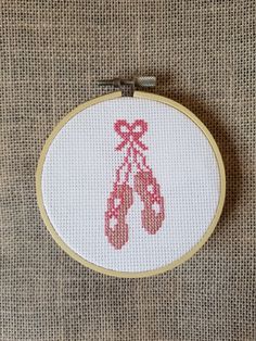 A ballet shoes counted cross stitch instant download pdf pattern. Design area measures approximately 1.36" x 2.86" on 14 count aida.  Finished example piece pictured is in a 4" hoop. I'm happy to help so please feel free to contact me with any questions. Ballet Cross Stitch, Rose Crafts, Shoes Pattern, Cross Stitch Baby, Shoe Pattern, Stitch Art, Simple Cross Stitch, Stitching Art, Perler Bead Patterns