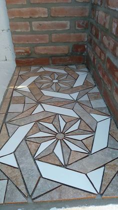 the floor is made up of different shapes and sizes, including an intricate tile design