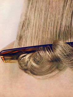 a close up of a comb and hair on top of a pile of blonde hair