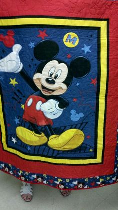 a child's mickey mouse bed spread is on display