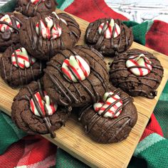 chocolate cookies with candy canes on a cutting board