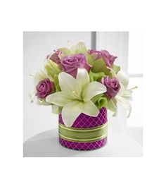 a purple and white vase filled with flowers