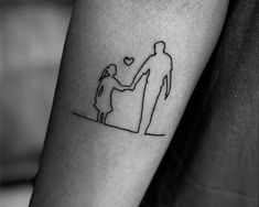 a man and woman holding hands with a heart tattoo on their arm