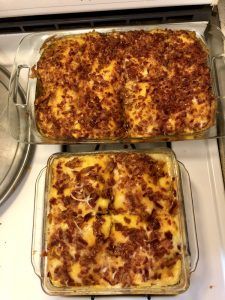 two casseroles sitting on top of a stove next to each other in pans