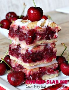 cherry shortcakes stacked on top of each other with cherries in the background