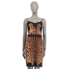 100% authentic Dolce & Gabbana leopard printed sleeveless dress in black, brown and beige silk (78%), cotton (12%), nylon (6%) and elastane (4%). Features semi sheer lace details at the hemline and the bust. Opens with a concealed zipper and a hook on the back. Has a black waistband that opens with three push buttons on the back. Lined in black silk (90%) and polyester (10%). Has been worn and is in excellent condition. Measurements Tag Size 40 Size S Bust 78cm (30.4in) to 88cm (34.3in) Waist 68 Beige Silk, Brown And Beige, Brown Silk, Lace Sheath Dress, Dolce & Gabbana, Sheer Lace, Black Silk, Sheath Dress, Lace Detail