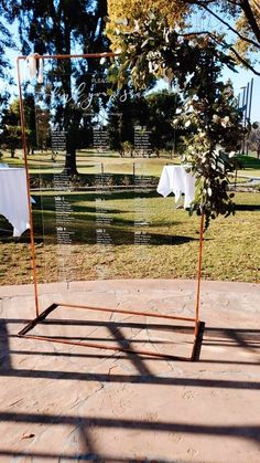 an outdoor ceremony setup with white linens and greenery