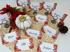 place cards with pumpkins and autumn leaves on a doily for guests to write names