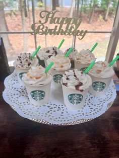 starbucks cupcakes are arranged on a cake plate