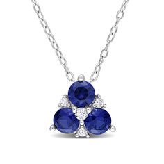 Display your sophisticated and elegant style with this blue and white lab-created sapphire flower pendant in silver. Crafted in sterling silver This design features a trio of 4.5mm round bright blue lab-created sapphires. Dainty white lab-created sapphires dot the floral design with a touch of shimmer. This pendant suspends along an 18.0-inch cable chain that secures with a spring-ring clasp. Blue Three Stone Sterling Silver Jewelry, White Lab, Peoples Jewellers, Necklace Clasps, Sapphire Pendant, Silver Prices, Sapphire Stone, Sapphire Gemstone, Chain Ring