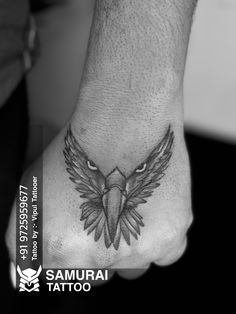 a black and white photo of an eagle tattoo on the foot