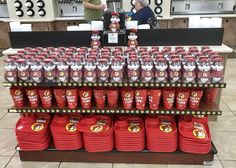 a display in a store filled with lots of red and white plastic cups next to each other