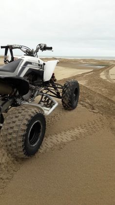 a four - wheeler is driving through the sand