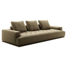 a couch with four pillows sitting on it's back end and one arm extended