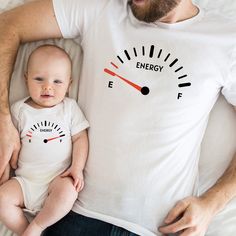 "The price for 1 T-shirt. Please add to your basket as many T-shirts as you like. Energy Gause Dad Son or Daughter Matching space t-shirt  Rev up your family's style with our Energy Gauge Dad-Son or Daughter Matching T-Shirt! This unique set features a t-shirt for dad with a fuel gauge design indicating \"Empty,\" representing his need for a refuel, while the accompanying baby t-shirt proudly displays a fuel gauge design showing \"Full,\" symbolizing the little one's endless energy. It's a fun and eye-catching way to showcase the special bond between father and child while adding a touch of automotive-inspired flair to your wardrobe. So buckle up and hit the road together, with these matching t-shirts that are sure to fuel up the fun!" Matching Family T-shirts For Father's Day, Funny White T-shirt For Father's Day, Funny Family Cotton T-shirt, Father's Day Family Cotton T-shirt, Funny Cotton T-shirt For Family, White Crew Neck T-shirt For Family Outings, Family Matching T-shirt For Father's Day, Father's Day Family Graphic Tee, Family Matching T-shirts For Summer