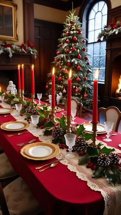 a christmas table setting with candles and decorations