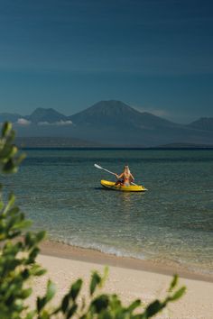 a person in a yellow kayak on the water