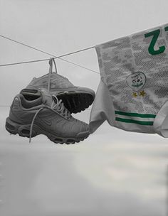 two pairs of shoes hanging on a clothes line with the number seven in front of them