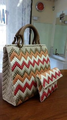 two bags sitting on top of a wooden table