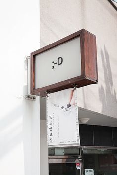 a sign hanging from the side of a building