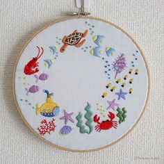 an embroidery hoop with sea animals and fish on it