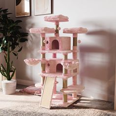 a pink cat tree in the corner of a room