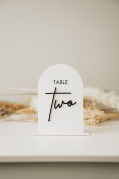 a table sign with the word two written on it