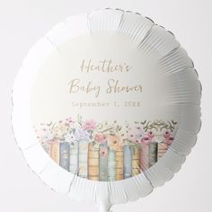 a round foil balloon with books on it and flowers in the background that says, hawthorne baby shower