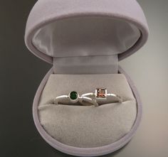 "Set of two Sterling Silver rings with your choice of premium natural birthstones.(restrictions apply). Size and shape can vary (triangle, round, oval, and square). Stones are between 3.5 and 4.5mm. Two rings are about 4mm wide at the bottom and 6mm at the top. Specify ring size and birthstone preference in a \"note to seller\" at check-out. It is always best to send me a note before ordering to work out the details." Gift Emerald Ring With Tension Setting, Emerald Ring With Tension Setting As Gift, Modern Sterling Silver Birthstone Ring With Accent Stones, Sterling Silver Birthstone Ring With Tension Setting, White Gold Birthstone Ring With Tension Setting As Gift, Gift White Gold Emerald Ring With Tension Setting, Modern Emerald Ring With Tension Setting As Gift, Birthstone Ring With Tension Setting As Gift, Formal Sterling Silver Stackable Rings With Birthstone