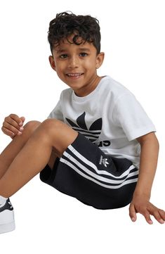 A bold Trefoil design dominates a kid-sized T-shirt that's paired with matching shorts finished with signature 3-Stripes racing down the sides. Shorts have elastic/drawstring waist; side-seam pockets 70% cotton, 30% recycled polyester Machine wash, tumble dry Imported Adidas Cotton Shorts With Three Stripes Branding, Adidas Cotton Shorts With Three Stripes, Adidas Casual Tops For Playwear, Casual Adidas Tops For Playwear, White Cotton Adidas Shorts, White Cotton Shorts With Three Stripes, Adidas Kids, Adidas Fashion, Matching Shorts