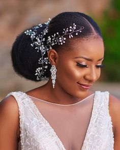 a woman in a white dress with a head piece on her head and an intricate hair comb