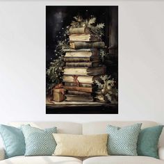 a christmas tree made out of books on top of a couch in front of a white wall