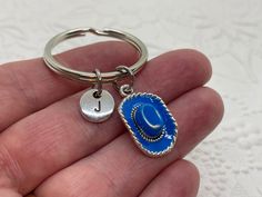 Cowboy Hat Keychain, Cowgirl Hat Keychain, Personalized Keychain, Initial Keychain, Cowboy Hat Charm, Initial Charm, Initial Key Ring Express yourself with a beautiful piece of charm jewelry or find the perfect gift for that special person! This keychain features a blue enamel and silver cowboy or cowgirl hat charm and an initial charm *Charms are made from a zinc alloy metal and are lead and nickel free. 🌺I offer 5 different styles of initials (the keychain is shown with the stamped circle sty Cowboy Hat Keychain, Blue Cowboy Hat, Keychain Blue, Initial Keychain, Keychain Personalized, Cowgirl Hat, Cowboy Cowgirl, Cowgirl Hats, Personalized Keychain