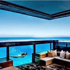 a living room filled with furniture and an ocean view