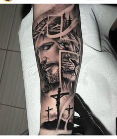 a man's arm with a cross and lion on it, in black and grey