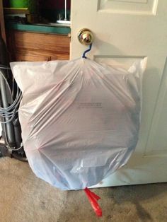 a plastic bag sitting on the floor in front of a door that has been taped to it