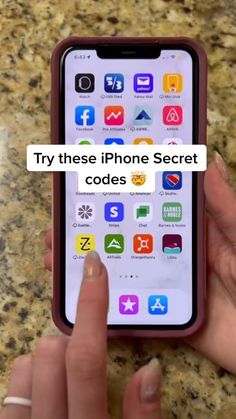 someone is holding an iphone with the text try these iphone secret codes on it