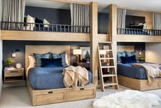 a bedroom with two bunk beds and a ladder