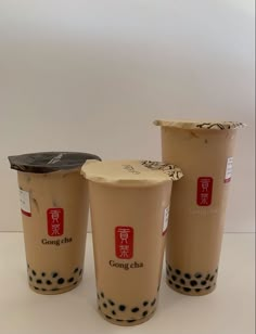 three cups with black dots on them sitting next to each other